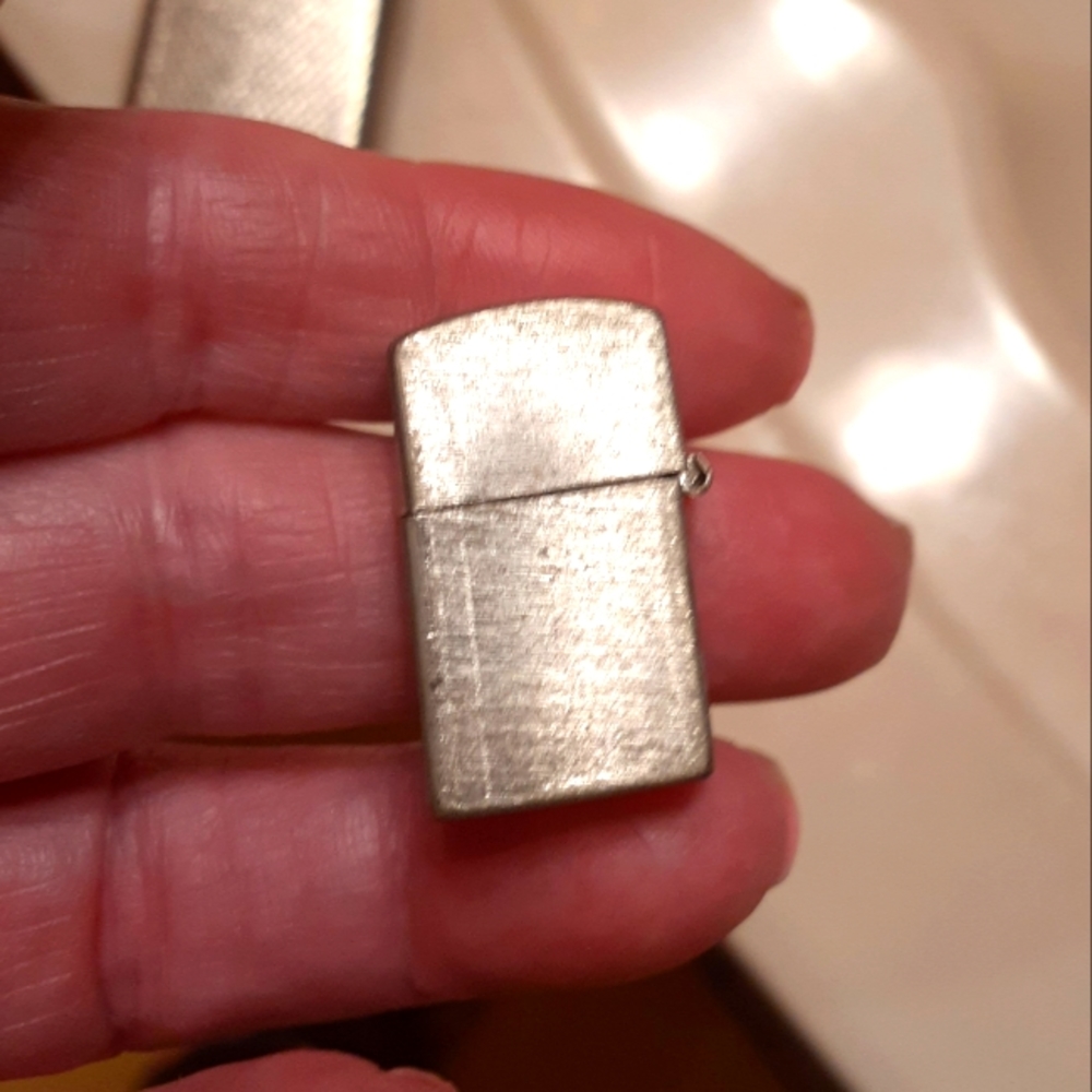 A VINTAGE TINY LIGHTER